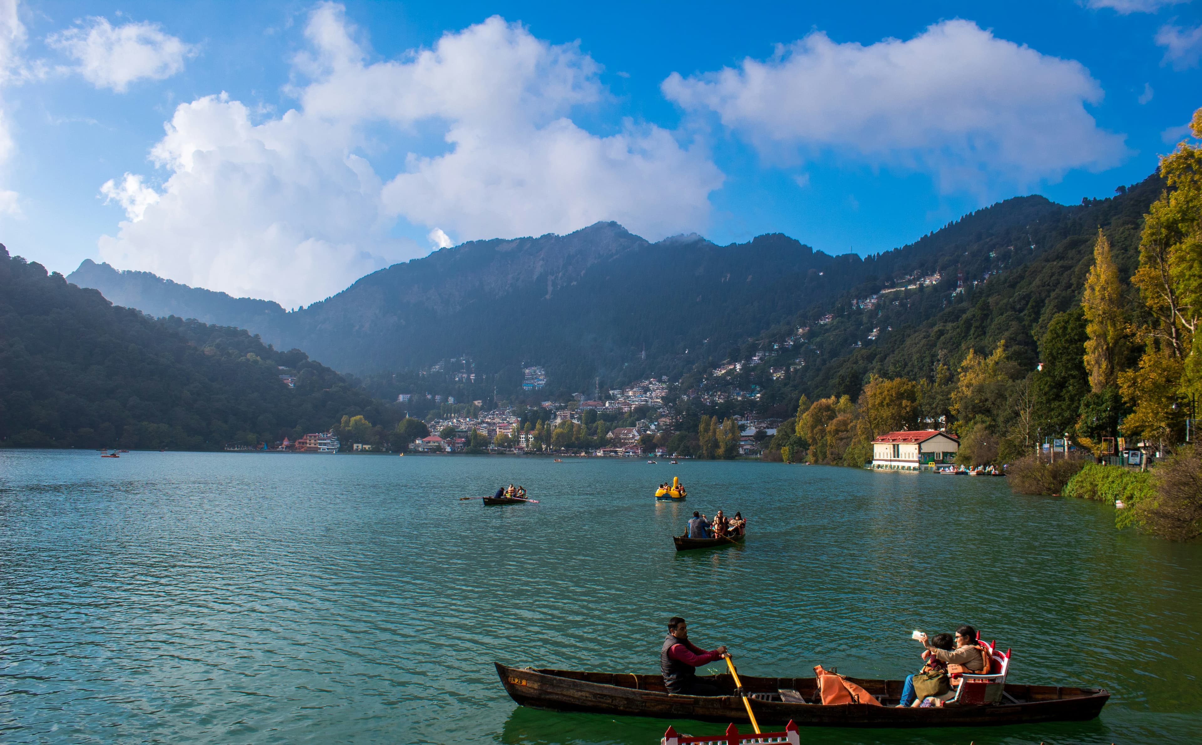 Boats on Nainital lake with hills and town in the background